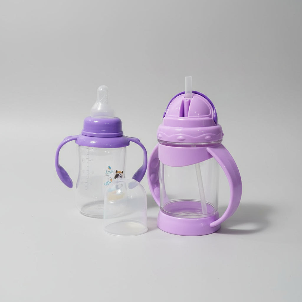 Purple baby bottles with handles on a wooden surface